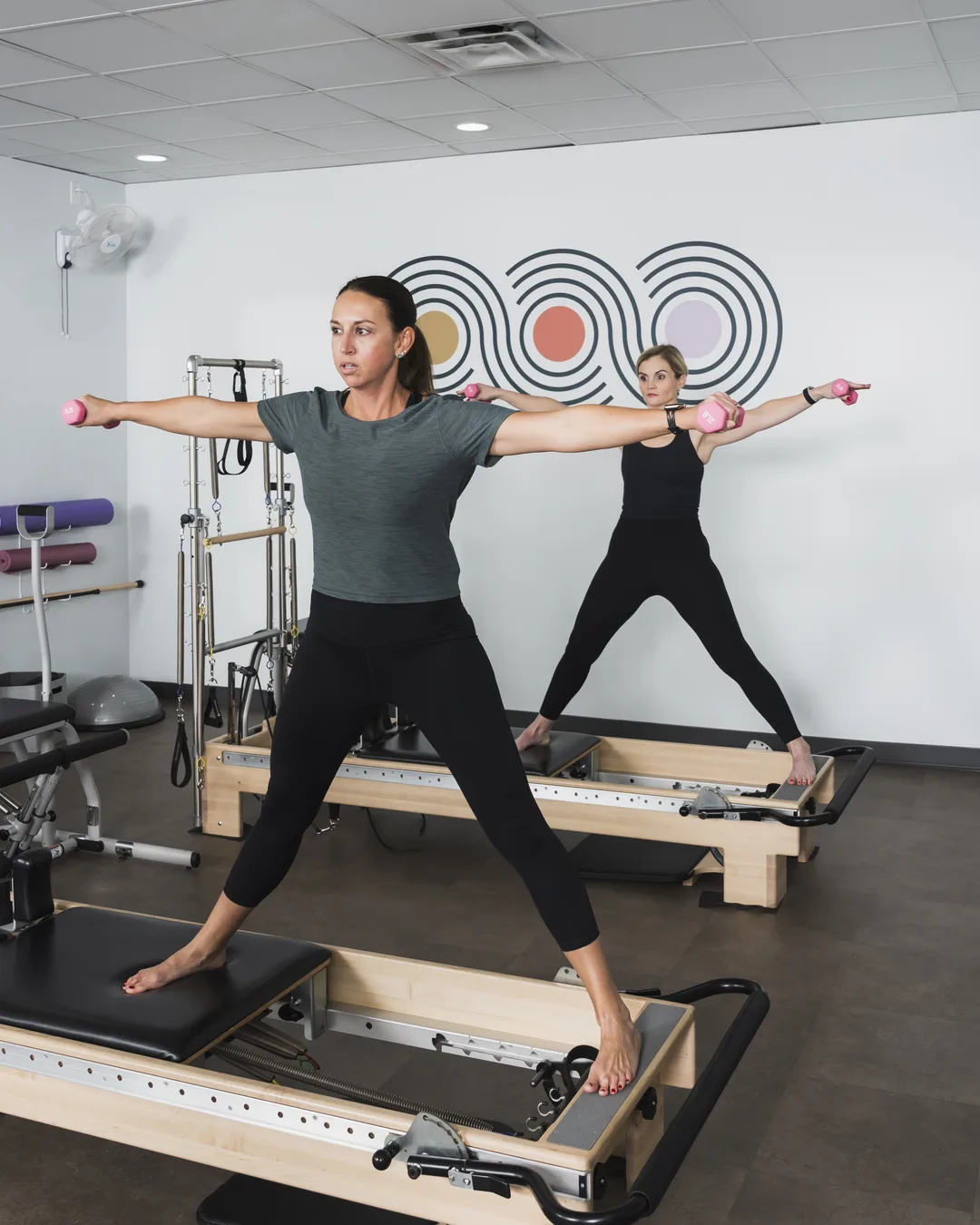Client on a Pilates reformer machine mid-exercise at Foundations Pilates and Wellness Studio in Indianapolis